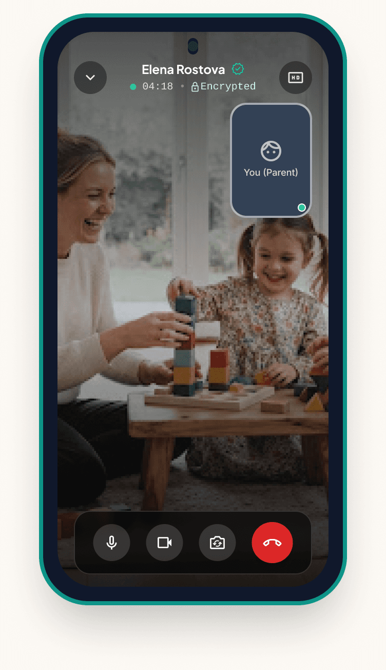 Sitluma app encrypted video call with sitter Elena Rostova, showing her playing with blocks alongside a young child, with the parent’s own preview and call controls.